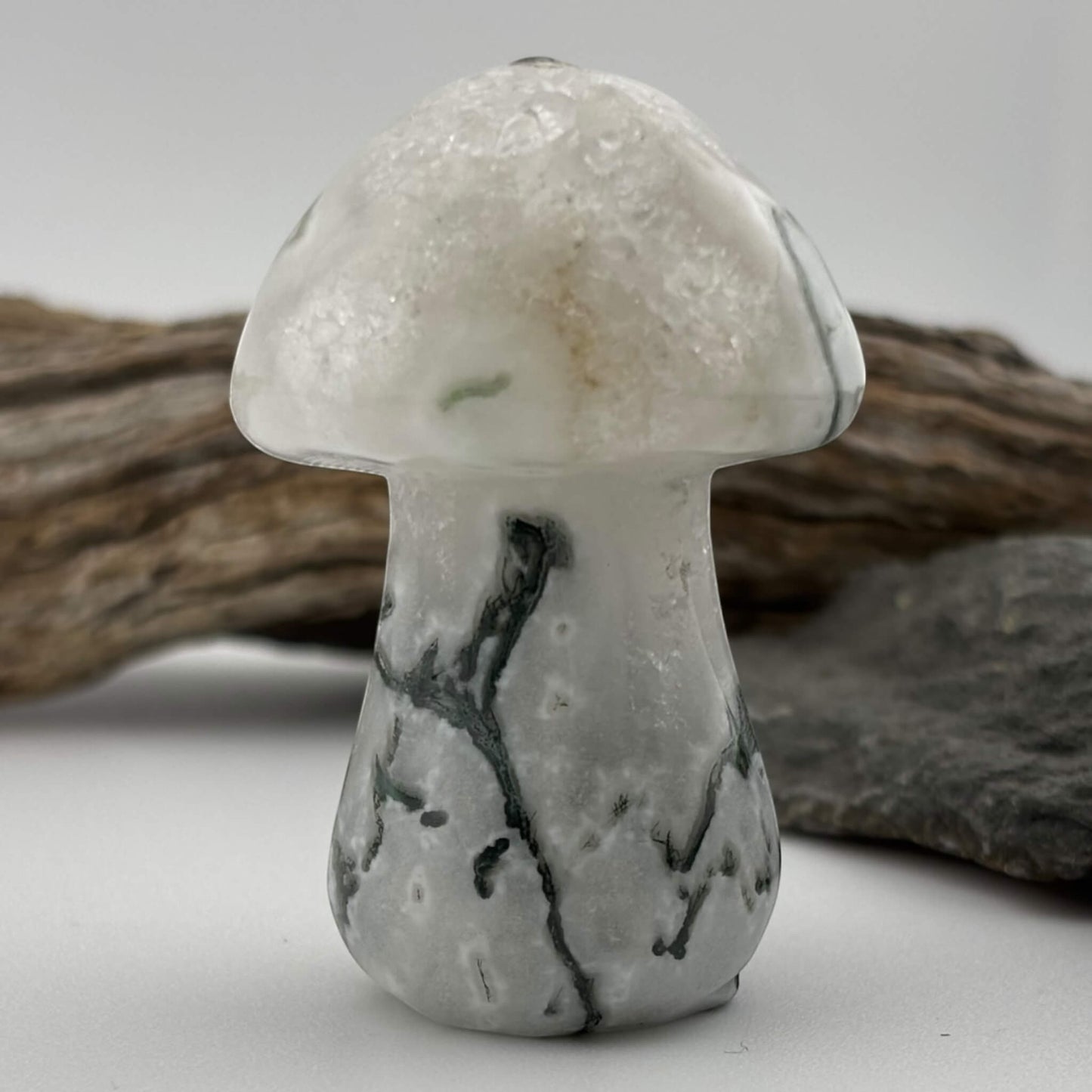 Decorative stone mushroom with a textured surface on a neutral background