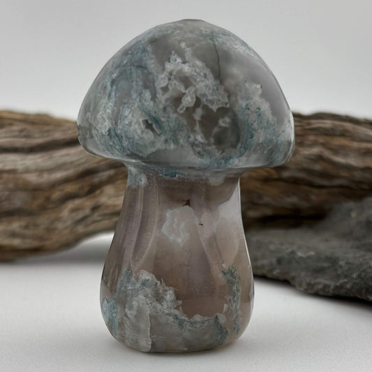 Decorative stone mushroom with a textured surface on a neutral background