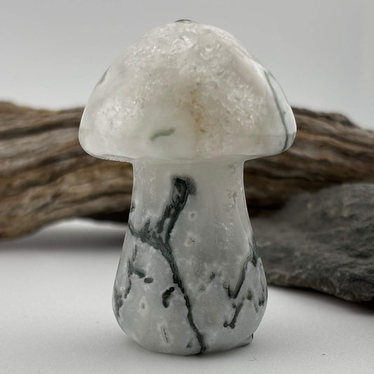 Decorative stone mushroom with a textured surface on a neutral background