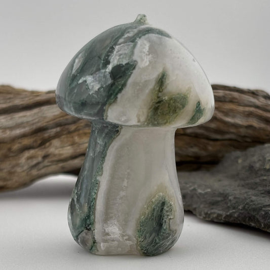 Decorative stone mushroom with green and white patterns on a neutral background