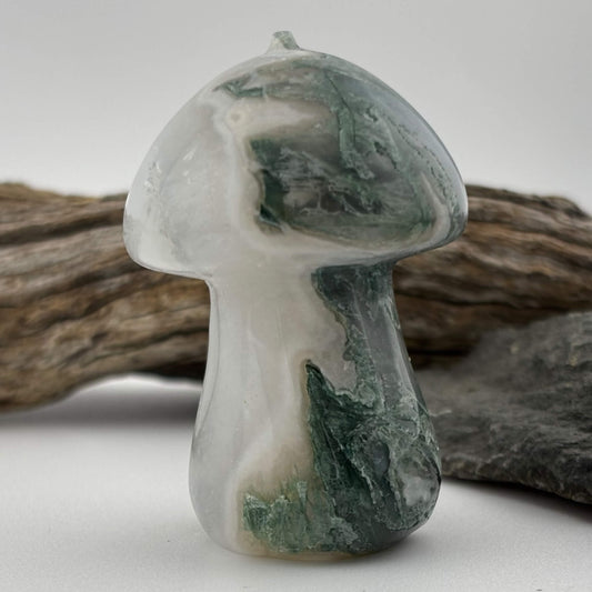 Decorative stone mushroom with green and white patterns on a neutral background