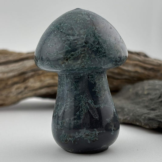 Decorative stone mushroom sculpture on a neutral background
