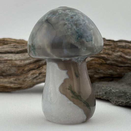 Decorative mushroom-shaped object with a textured surface on a neutral background