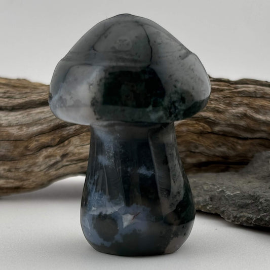 Black and gray stone mushroom sculpture on a neutral background